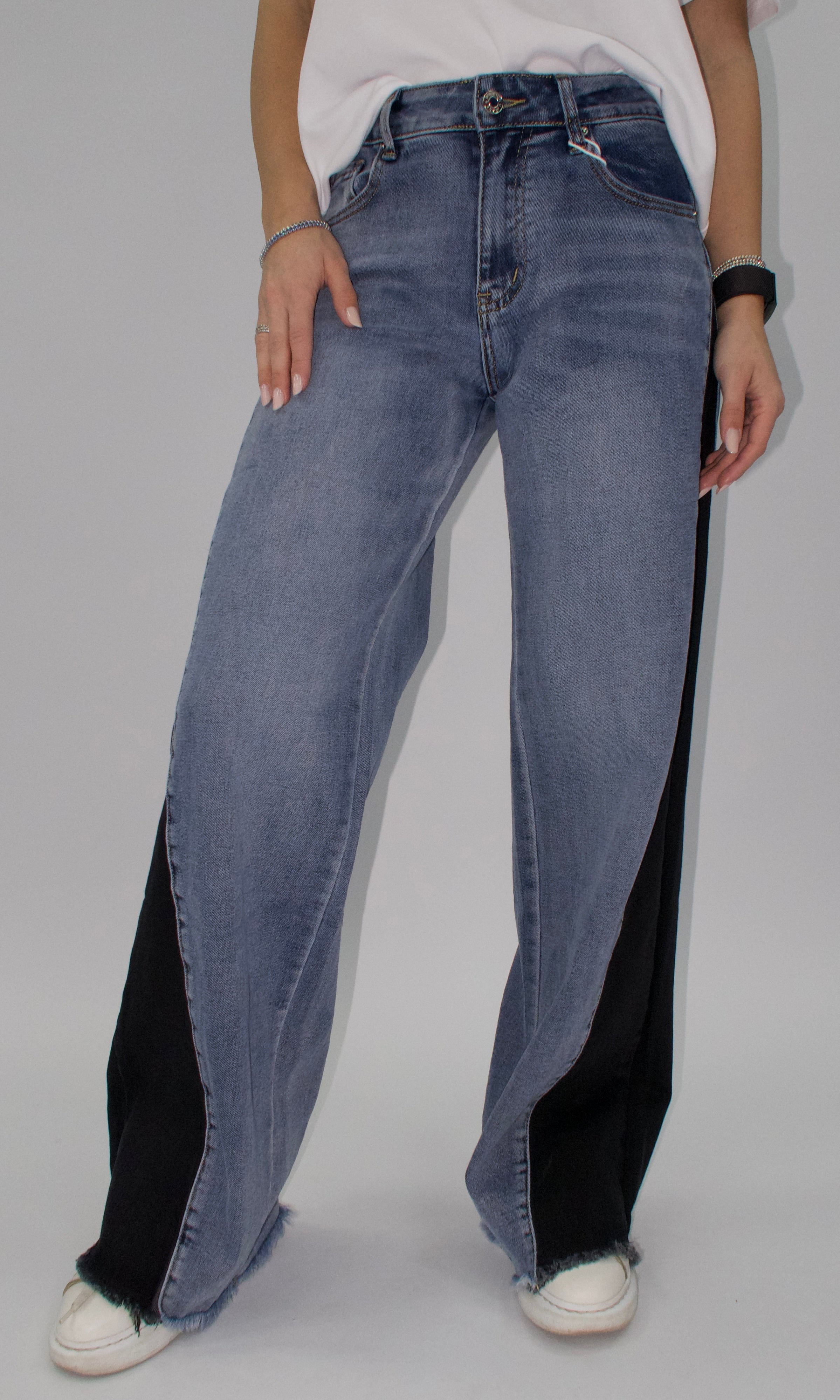 Wide-leg jeans with black detailing and a frayed hem